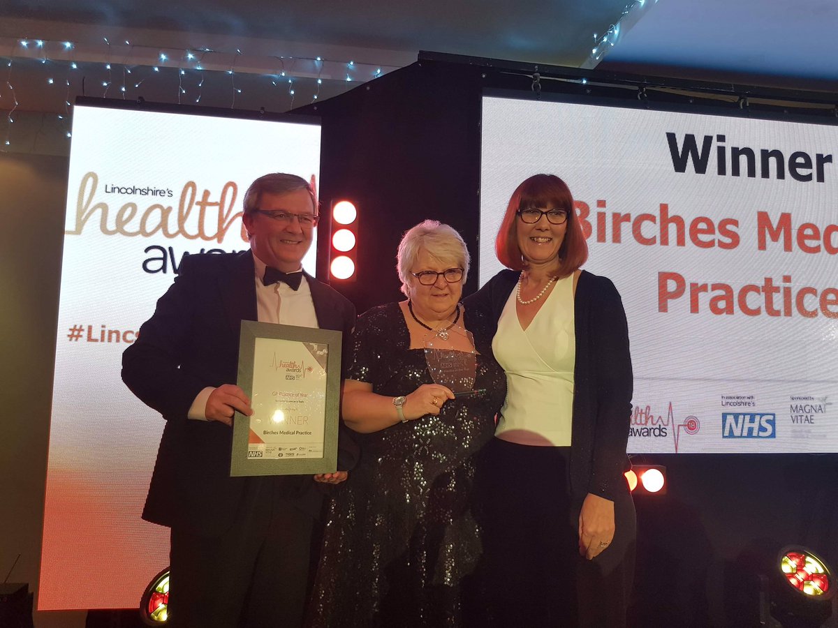 one man and two ladies at the practice of the year awards